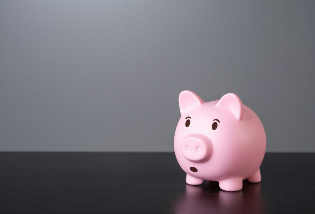 Surprised and worried piggy bank. Financial risks and saving savings.